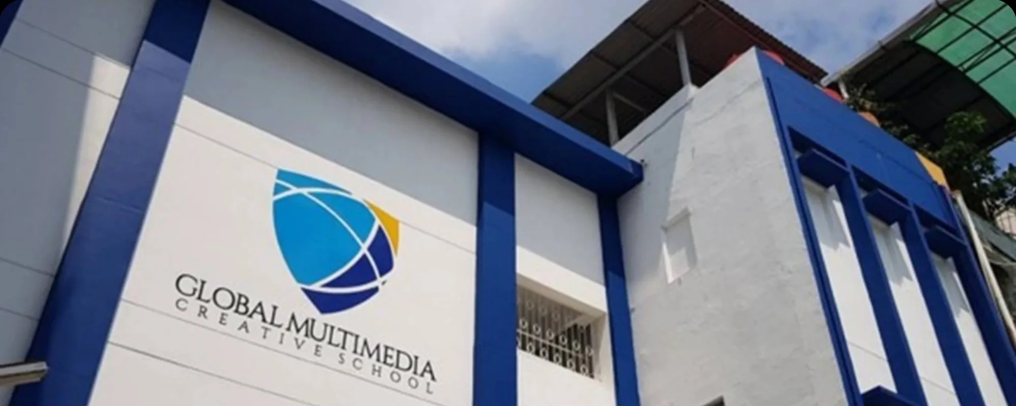 The GMC Jakarta campus building, blue and white with the school logo